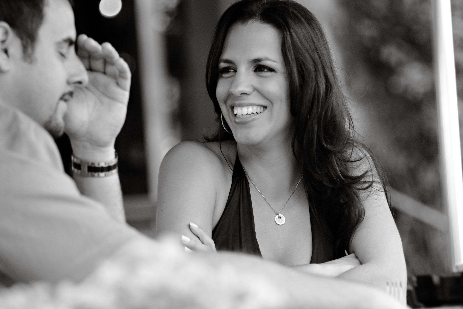 Two adults having a candid conversation at a cafe
